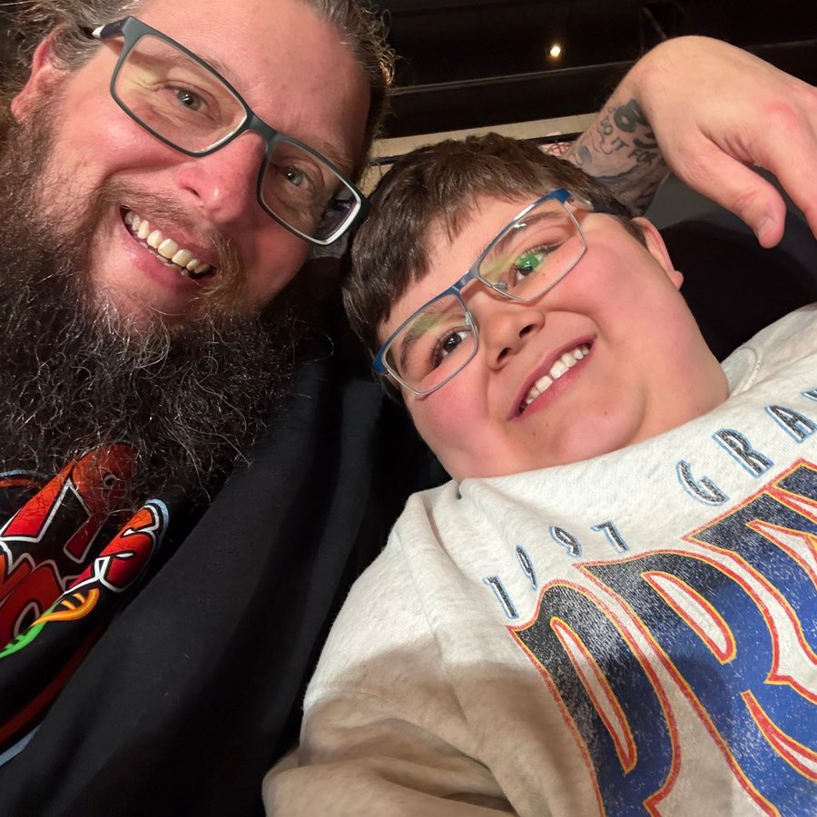 Steve, founder of 79 Exons, smiling with his son at an event